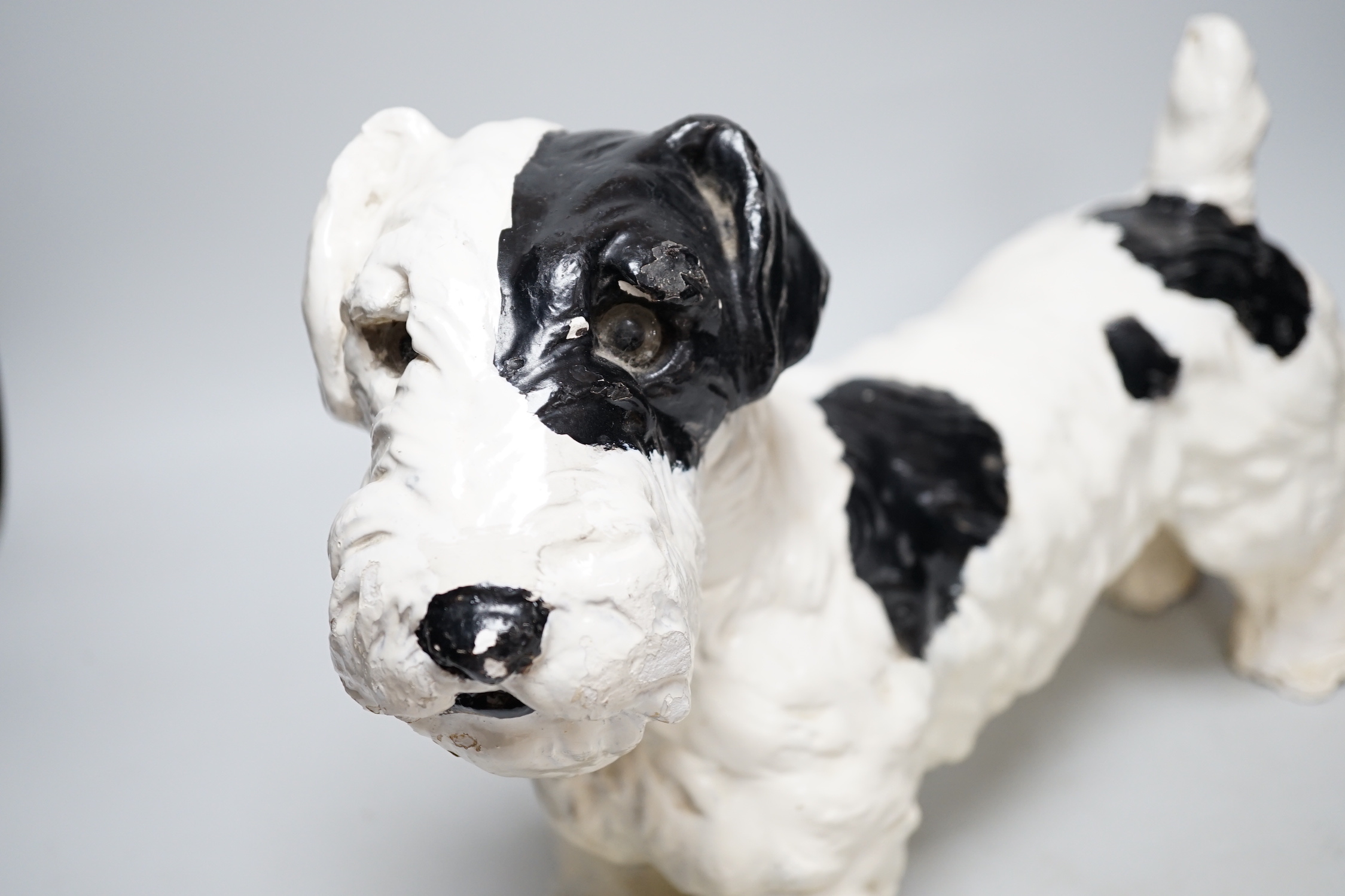 A painted plaster model of a terrier dog, 28cm high, 41cm long